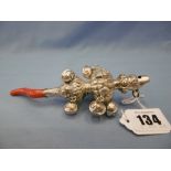 A white metal and coral teething rattle
