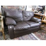 A brown leather two seater sofa