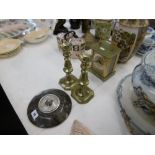 A pair of brass candlesticks with wax pushers,