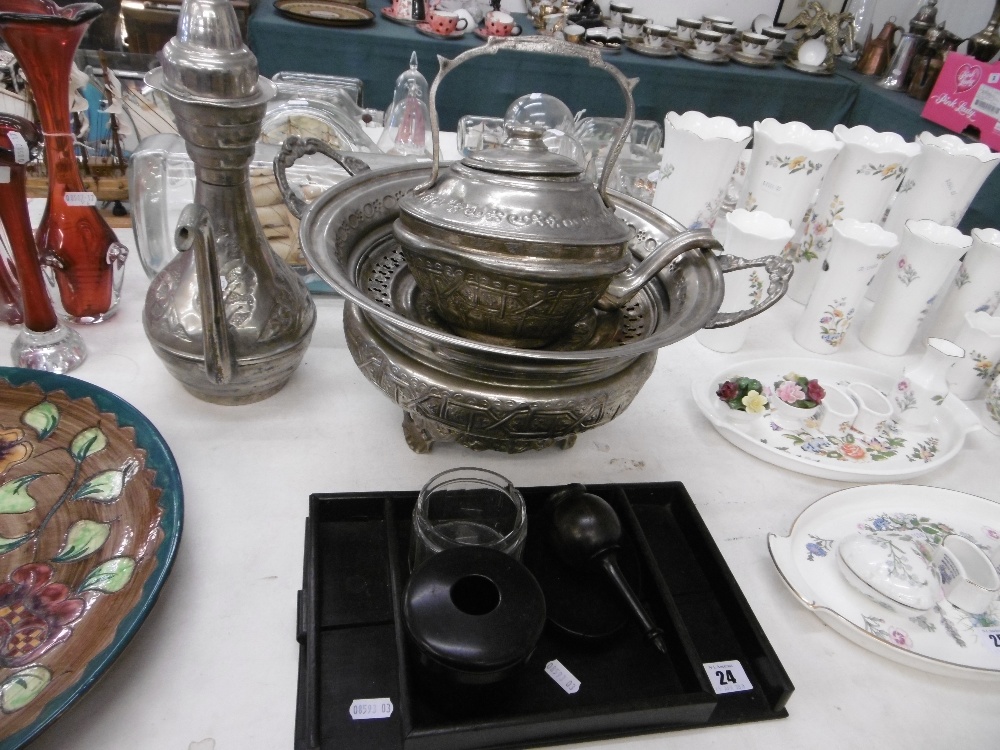 An assortment of metalware and ebony wood items