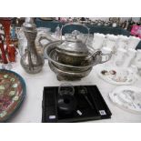 An assortment of metalware and ebony wood items