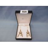 A pair of drop earrings set with diamonds and an oval pearl