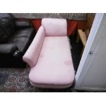 A pink upholstered chaise lounge