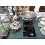 An assortment of metalware and ebony wood items