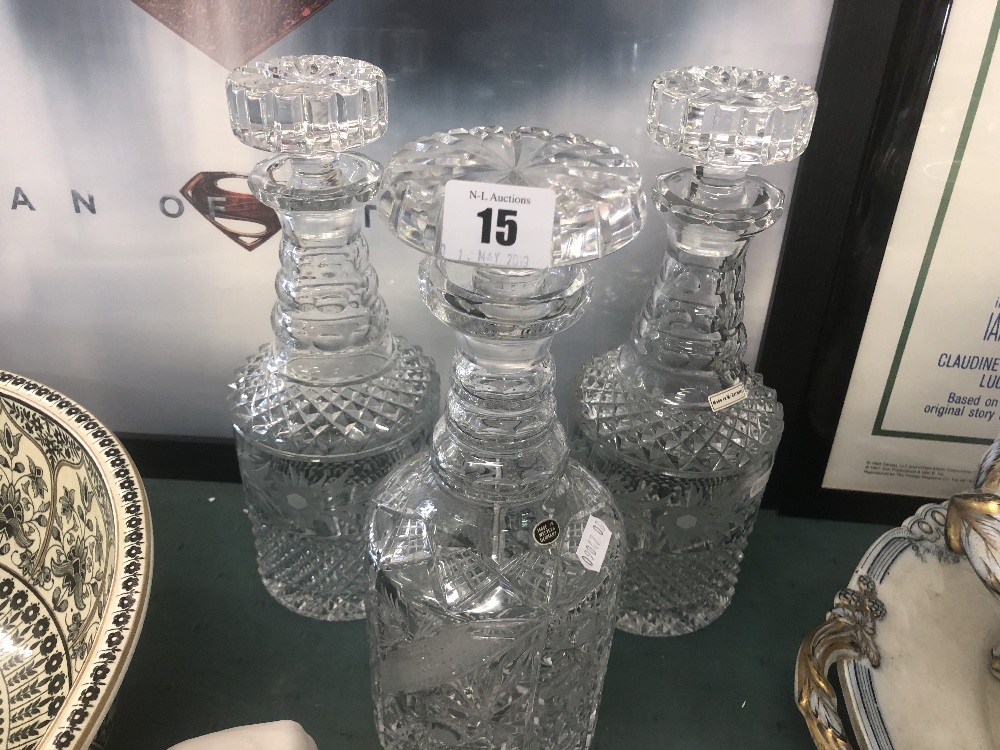 A pair of cut glass decanters plus one other