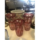 A pair of two plus one other cranberry overlay glass vases