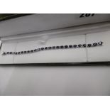 A treated sapphire and diamond 18ct white gold line bracelet 17.