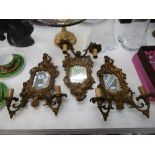A set of three gilt metal rococo style wall sconces