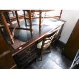 A mahogany desk on ball and claw feet