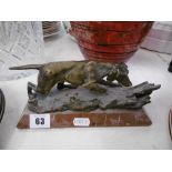 A bronze of pointer dog on red marble plinth