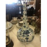 A blue and white hand painted Chinese vase with slender neck and cover decorated with warriors and
