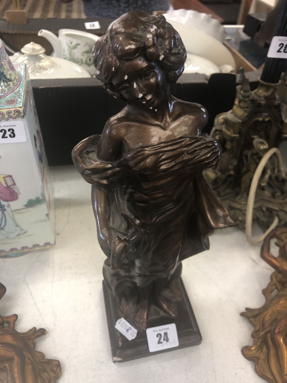 A bronzed figure of a lady