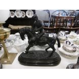 A bronze sculpture of a jockey and horse