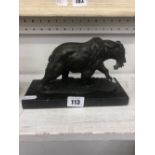 A small bronze sculpture of bear with salmon in its mouth