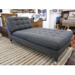 A modern grey upholstered day bed