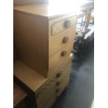 A chest of four drawers and a bed side chest