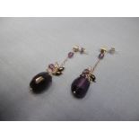 A pair of silver and amethyst drop earrings