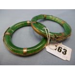 A pair of Chinese Jade bangles (damaged) with gilt white metal dragon mounts