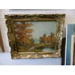 A gilt framed country lake scene