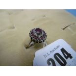 A 9ct yellow gold ruby and diamond cluster ring size O