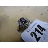 A 9ct yellow gold garnet and diamond cluster ring