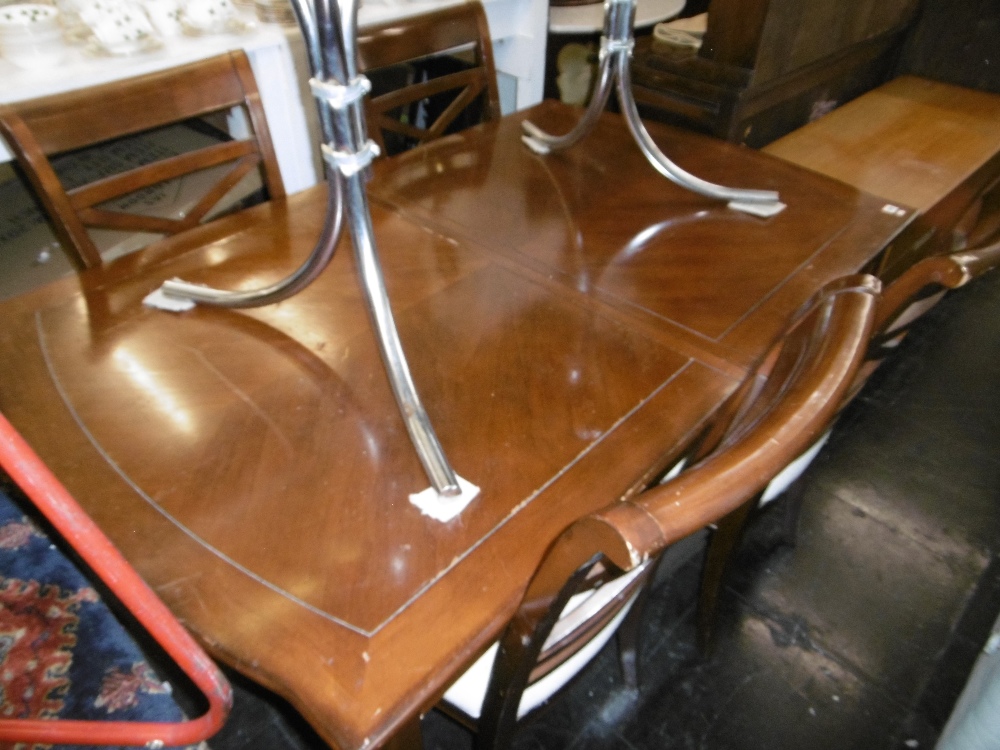 A contemporary extending dining table with two leaves,