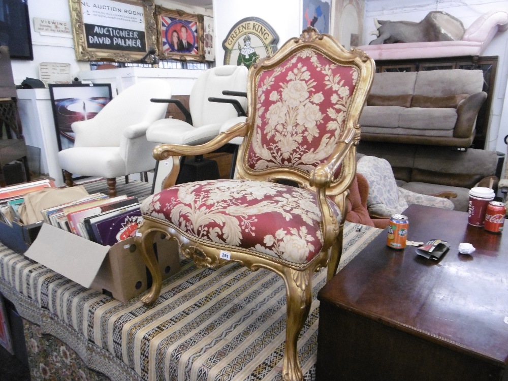 An upholstered gilt armchair