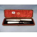 A hallmarked silver carving set with mother of pearl handles