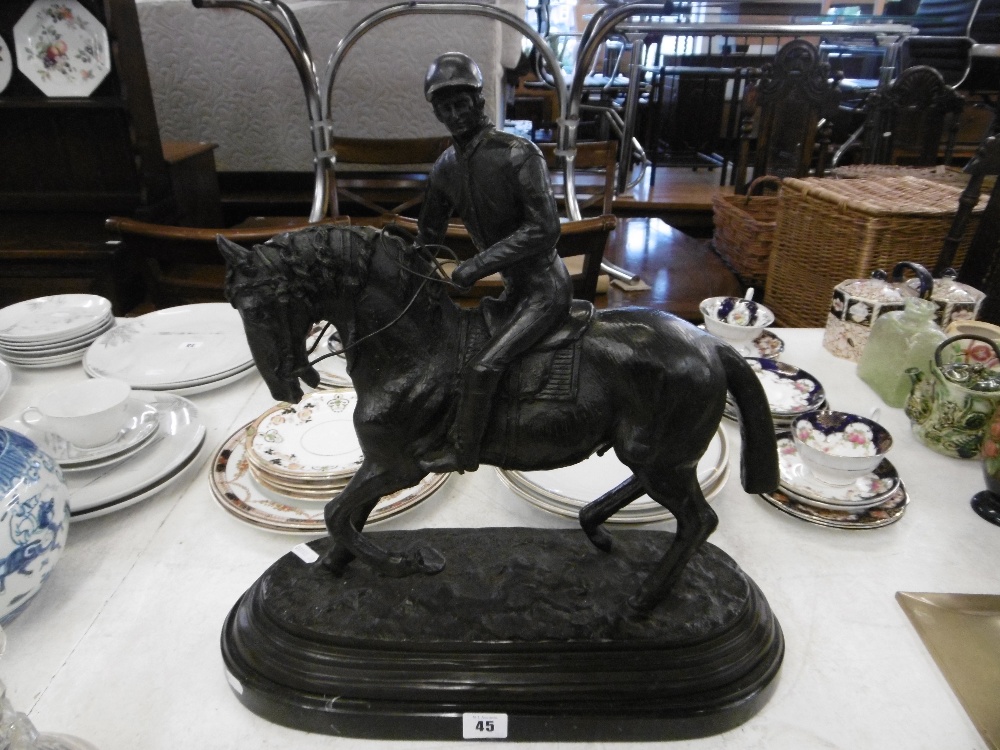 A bronze sculpture of a jockey and horse