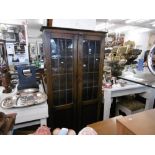 A leaded oak two door bookcase