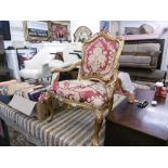 An upholstered gilt armchair