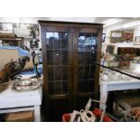 A leaded oak two door bookcase