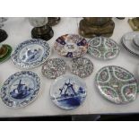 A quantity of assorted cabinet plates including Delft and Imari