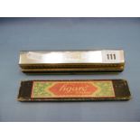 A cased M Hohner harmonica