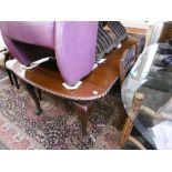 A mahogany extending dining table with a leaf and winder