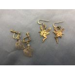A pair of silver fairy earrings and one other