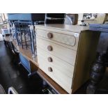 A chest of four drawers and a bed side chest