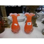 A pair of orange Murano glass vases