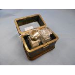 A 19th century leather bound casket brass and bevelled glass to lid containing two scent/smelling