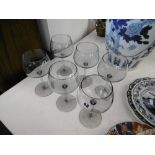 A set of six good quality smoked glass wine glasses