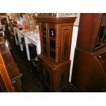 A mahogany two door cabinet on cupboard base