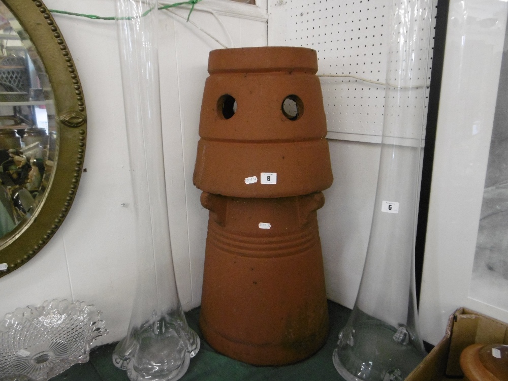 A large terracotta plant holder