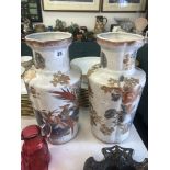 A pair of white and orange oriental vases