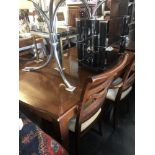 A contemporary extending dining table with two leaves,