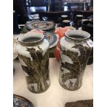 A pair of art deco style hand painted porcelain vases