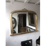 A gilt over mantle mirror