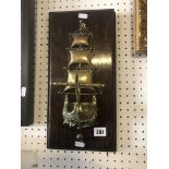 A brass and oak navy ship plaque