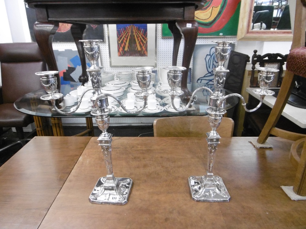A pair of hallmarked silver candleabras, one candlearbra weighs at 1.725kg and other 1.