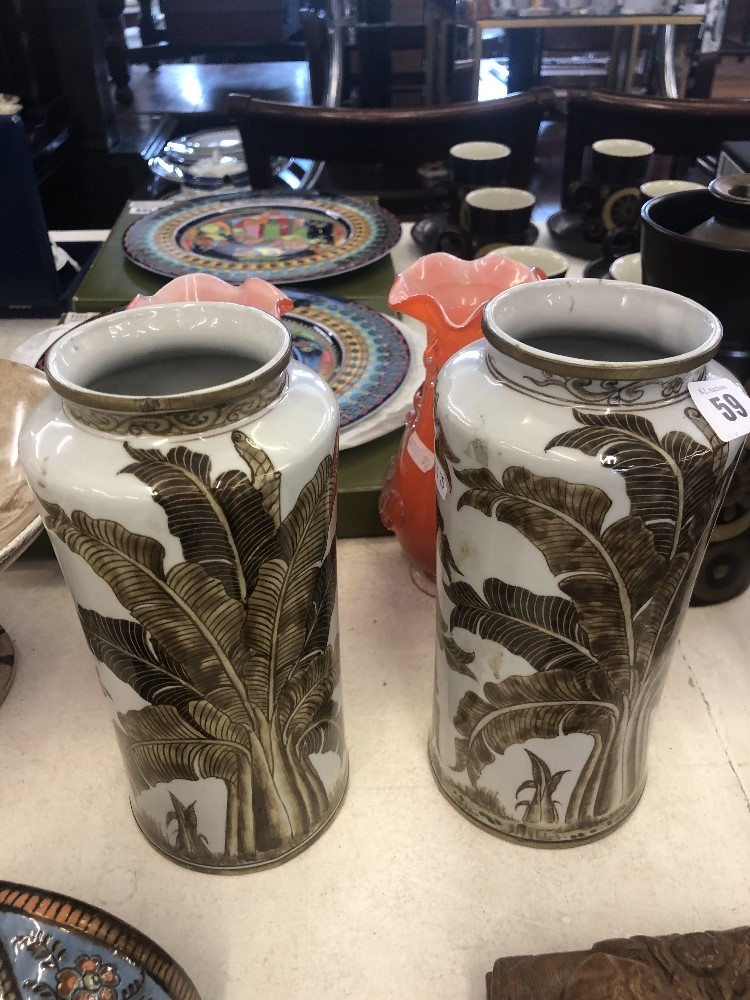 A pair of art deco style hand painted porcelain vases