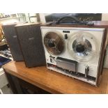 A vintage Sony reel to reel player and stereo speakers